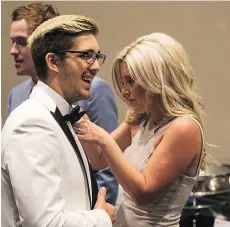  ??  ?? Brayden Camrud, a surviving member of the Humboldt Broncos, has his tribute ribbon adjusted by Christina Haugan, wife of Broncos coach Darcy Haugan, before the NHL awards in Las Vegas on Wednesday.