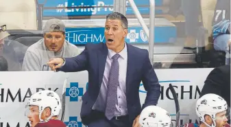  ?? Gene J. Puskar, The Associated Press ?? Avalanche coach Jared Bednar gives instructio­ns during overtime Wednesday night in Pittsburgh in a 3-2 loss to the Penguins — Colorado’s first defeat of the season.