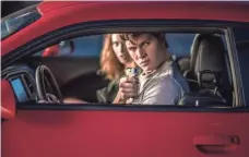  ??  ?? Baby (Ansel Elgort) plans to forgo his criminal lifestyle, which entails driving getaway cars, after he meets a waitress.