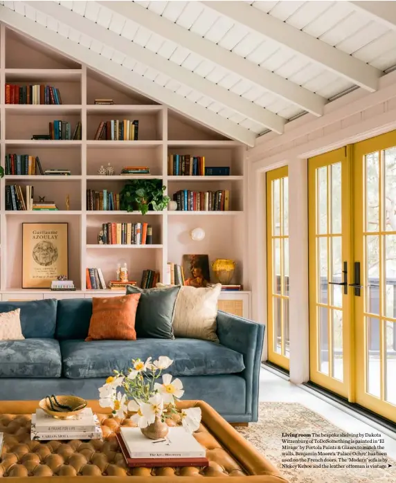  ??  ?? Living room The bespoke shelving by Dakota Witzenburg of ToDoSometh­ing is painted in ‘El Mirage’ by Portola Paints & Glazes to match the walls. Benjamin Moore’s ‘Palace Ochre’ has been used on the French doors. The ‘Modern’ sofa is by Nickey Kehoe and the leather ottoman is vintage