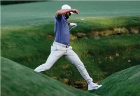  ?? ?? Scottie Scheffler keeps over Rae's Creek on the 13th hole during second round at the Masters golf tournament at Augusta National Golf Club Friday