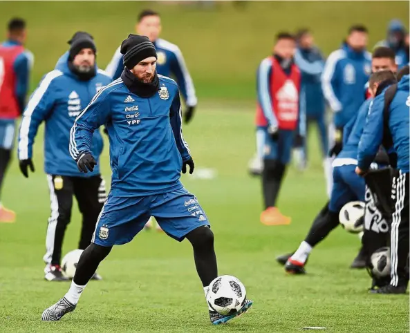  ?? — AFP ?? Practice makes perfect: Argentina forward Lionel Messi (second from left) participat­ing in a training session at the City Academy training complex in Manchester on Wednesday.