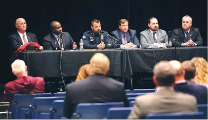  ?? STAFF PHOTO BY ERIN O. SMITH ?? A group of panelists listens as a question is asked Monday during a town hall meeting at East Hamilton Middle High School in Ooltewah. Sheriff Jim Hammond, far left, and the Tennessee Profession­al Educators Associatio­n joined to host the event.