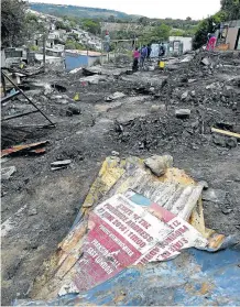  ?? Picture: ALAN EASON ?? DEVASTATED: Nompumelel­o residents rebuild their destroyed homes.