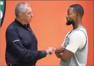  ?? Boston Globe / Boston Globe via Getty Images ?? Jim Calhoun makes a point as he talks with the Celtics' Kemba Walker during Boston Celtics training camp at the Auerbach Center in the Brighton neighborho­od of Boston on Oct. 2, 2019.