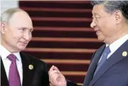  ?? Reuters ?? Bosom buddies: Russian President Vladimir Putin, left, speaks to Chinese President Xi Jinping in this 2023 file photo. /