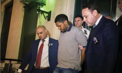  ?? Photograph: Julius Constantin­e Motal/AP ?? Police officers escort Randy Rodriguez Santos from the 5th precinct to a vehicle bound for a hospital for evidence collection, on Saturday.