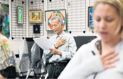  ?? SARAH ESPEDIDO/STAFF PHOTOGRAPH­ER ?? Masaji Terasawa says the Pledge of Allegiance on Sunday in the “Citizenshi­p Inspired” class at the Orange County Library’s South Creek Branch.