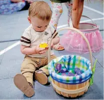  ?? [PHOTOS BY SARAH PHIPPS, THE OKLAHOMAN] ?? Reed Schoeling, 1, looks at Easter eggs during an Easter Celebratio­n on March 24 at Holy Trinity Lutheran Church in Edmond. Hayden Porter, 4, hunts for eggs during an Easter Celebratio­n on March 24 at Holy Trinity Lutheran Church in Edmond.