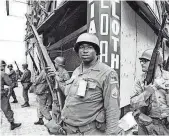  ?? FILE PHOTO BY MARTY LEDERHANDL­ER, AP ?? National Guardsmen stand at the corner of Springfiel­d Avenue and Mercer Street in Newark, a flash point for days of violence and looting.