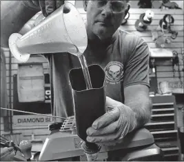  ?? [FRED SQUILLANTE/DISPATCH] ?? John Bailey of Como Mower Service preps a mower for spring use.