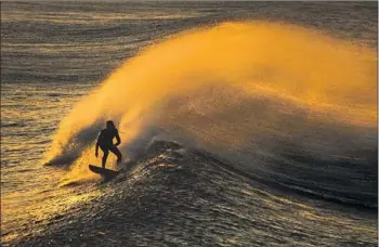  ?? Allen J. Schaben Los Angeles Times ?? A SUPERIOR Court judge is hearing a case that alleges certain state coastal commission­ers repeatedly failed to disclose private talks with parties over proposed projects. Above, a surfer in Huntington Beach.