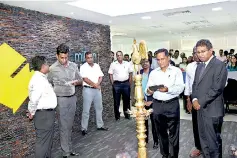  ??  ?? Prasath Nanayakkar­a (Chairman, CEO and Founder of Auxenta) lighting the electronic oil lamp alongside Harsha de Silva (Deputy Minister of Foreign Affairs)