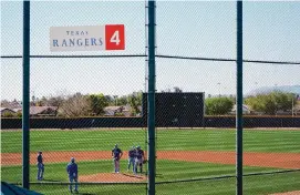  ?? Lindsey Wasson/ Associated Press ?? The Rangers’ 5-4 spring training win over the Kansas City Royals on Friday was the fans’ first chance to see their team take the field as the reigning World Series champions.