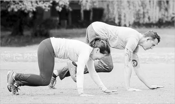  ?? PHOTOS BY BETTINA HANSEN
SEATTLE TIMES ?? Nicole Tsong works with trainer Kyle Long for a crawling and locomotion workout