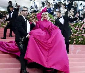  ?? Evan Agostini/Invision/AP ?? Designer Brandon Maxwell with Lady Gaga, who is wearing a gown he designed for the Metropolit­an Museum of Art's Costume Institute benefit in May 2019.