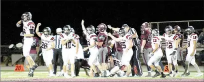  ??  ?? Blackhawks rejoice over a recovered ball Friday night.