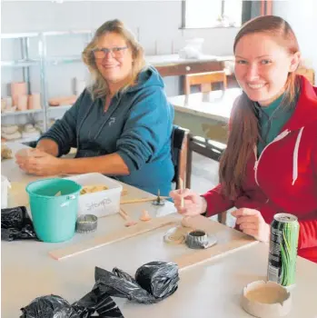  ??  ?? Eva Renbjor and Ida Marie Renbjor play with clay shapes.