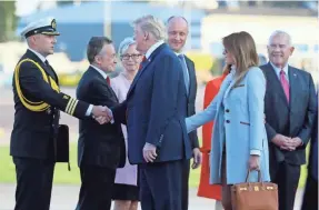  ?? MAURI RATILAINEN/EPA-EFE ?? President Donald Trump and first lady Melania Trump are welcomed on their arrival Sunday at Helsinki Airport.