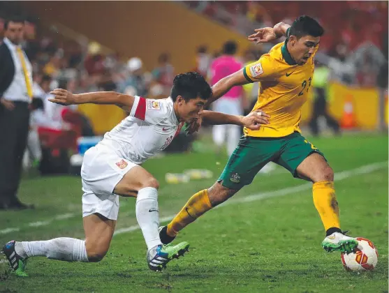  ?? RARE SIGHT: Australia’s Mark Bresciano takes on Zheng Zhi of China during an AFC Asian Cup quarter- final at Suncorp Stadium. Picture: DARREN ENGLAND ??