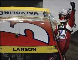  ?? (Logan Riely/getty) ?? Kyle Larson, driver of the #5 Valvoline Chevrolet, celebrates after winning the Cup Series Bass Pro Shops Night Race at Bristol Motor Speedway Saturday.