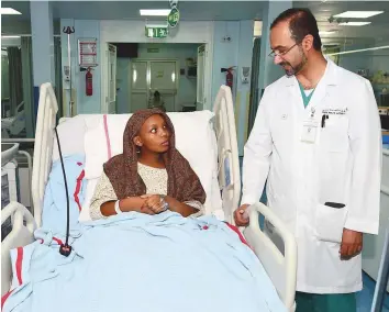  ?? Atiq ur Rehman/Gulf News ?? Dr Khalid Abdullah Al Awadi with Purity Warimu, who was involved in a horrific road accident in which a car wheel ran over her left foot. Brain injuries also left her partially paralysed.