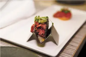  ??  ?? LEFT: A pastrami taco at Eloisa during the food tour Friday.
BELOW LOW: Nick Peña, owner of Food Tour New Mexico, tells guests Friday about the history and food of Northern New Mexico at Julia, A Spirited Restaurant & Bar at La Posada de Santa Fe.