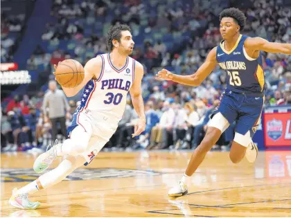  ?? GERALD HERBERT/AP PHOTOS ?? 76ers guard Furkan Korkmaz drives down court against Pelicans guard Trey Murphy III during the first half Wednesday night’s game in New Orleans.