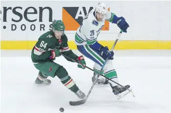  ?? STACY BENGS/THE ASSOCIATED PRESS ?? The Minnesota Wild’s Mikael Granlund and Canuck Brandon Sutter battle for the puck Tuesday in St. Paul, Minn. Vancouver won 1-0 on Anders Nilsson’s second shutout of the season.