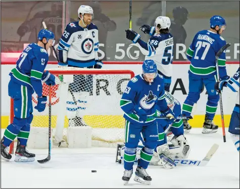  ?? — USA TODAY SPORTS FILES ?? A despondent group of Canucks players react after being scored upon during their 5-1 loss to the Jets on March 24. They have not played since and it's still possible they won't play again the rest of the season.