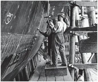  ??  ?? Hammer and tongs: Hand-riveters work on Titanic’s sister ship Britannic in 1914