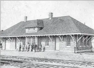  ?? BEATON INSTITUTE PHOTO ?? This photograph from the Beaton Institute archives shows railway workers standing in front of Sydney’s original train station. The picture was taken in the early 1890s.