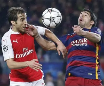  ?? MANU FERNANDEZ/THE ASSOCIATED PRESS ?? Arsenal’s Mathieu Flamini, left, and Barcelona’s Luis Suarez fight for possession during Champions League action.