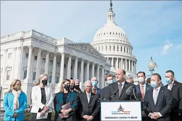  ?? CHIP SOMODEVILL­A/GETTY ?? Rep. Tom Reed, R-N.Y., at lectern, and a bipartisan group of lawmakers hold a news conference on virus relief Thursday.