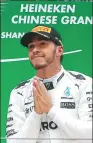  ?? ALY SONG / REUTERS ?? Mercedes driver Lewis Hamilton celebrates on the podium after winning the Chinese Grand Prix at Shanghai Internatio­nal Circuit last weekend.