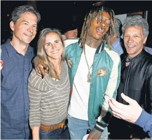  ?? JOE SCARNICI, GETTY IMAGES FOR FANATICS ?? Brandi Chastain attends a Super Bowl party in February with, from left, Fanatics Inc. CEO Doug Mack, Wiz Khalifa and Jon Bon Jovi.
