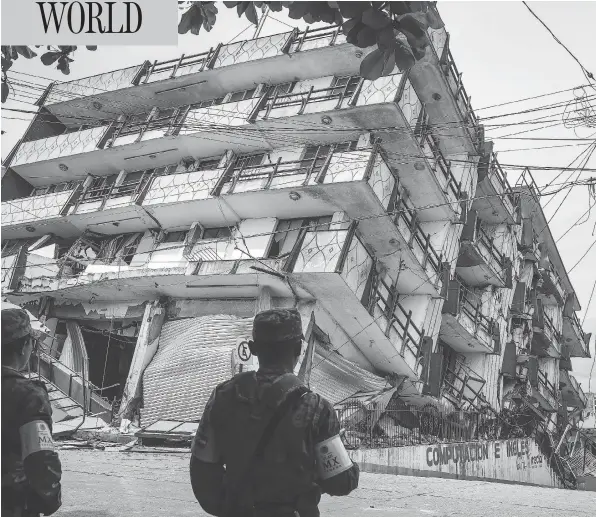  ?? VICTORIA RAZO/AFP/GETTY IMAGES ?? Soldiers stand guard a few metres from the Sensacion hotel in the town of Matias Romero, Mexico. The building collapsed when an 8.1-magnitude earthquake struck late Thursday. Mexico’s most powerful quake in a century killed scores of people after it struck the Pacific coast, wrecking homes and sending families fleeing into the streets.