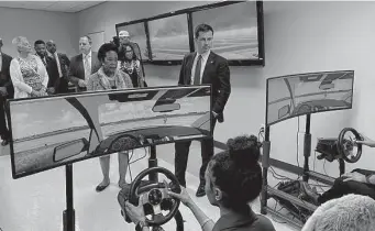  ?? Photos by Dug Begley/Staff ?? Transporta­tion Secretary Pete Buttigieg and U.S. Rep. Sheila Jackson-Lee, D-Houston, watch a flight simulation by Texas Southern students during a tour of the university’s aviation program.