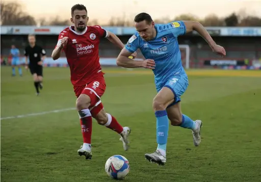  ??  ?? Cheltenham’s Chris Hussey looks to get past Crawley Town’s Jack Powell