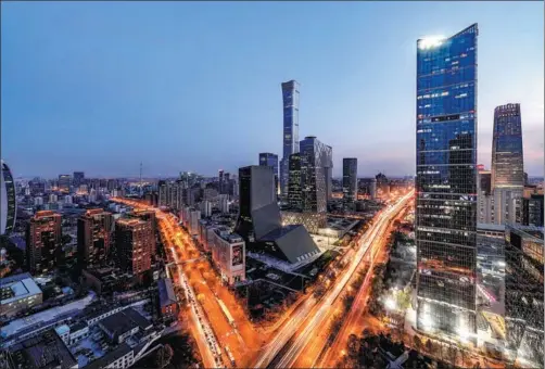  ?? PROVIDED TO CHINA DAILY ?? The night view of Beijing’s Central Business District on Dec 5, featuring CITIC Tower (center), the tallest skyscraper in the national capital, and many other office buildings. Beijing is set to welcome an influx of high-tech firms supported by favorable policies, which will increase demand for office leasing.