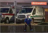  ?? DAMIAN DOVARGANES / AP ?? Darren Arthur, an environmen­tal services worker, takes a break outside the Los Angeles County+USC Medical Center emergency ramp in Los Angeles late Wednesday.