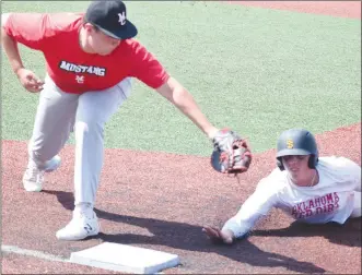  ?? RICK PECK/SPECIAL TO MCDONALD COUNTY PRESS ?? McDonald County first baseman Ethan Lett reaches to put the tag on an Oklahoma Red Dirt baserunner during McDonald County’s 7-6 win on July 20 in the Joplin 18U Baseball Showcase Tournament.