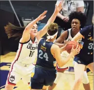  ?? David Butler II / USA Today ?? UConn guard Nika Muhl (10) defends against Marquette guard Selena Lott (24) on March 8. The Huskies’ game against Marquette scheduled for Wednesday at the XL Center was canceled due to COVID issues at Marquette.