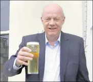  ??  ?? MP Damian Green had a pint after opening the cafe and shop