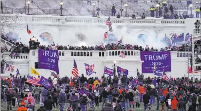  ?? John Minchillo The Associated Press ?? Violent insurrecti­onists loyal to then-president Donald Trump storm the Capitol in Washington, D.C., on Jan. 6.