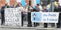  ??  ?? Protests outside the service at Westminste­r Abbey