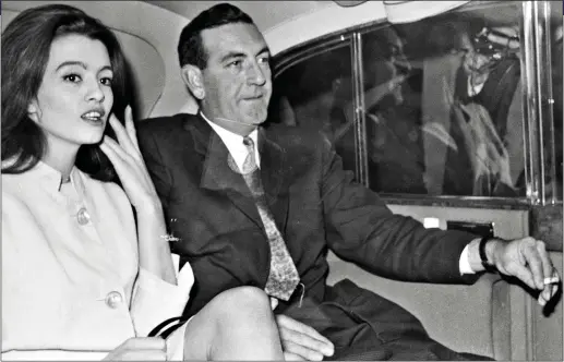  ??  ?? SCANDAL: Christine Keeler and News of the World reporter Peter Earle, who uncovered the Profumo affair, taking a taxi to court in October 1963