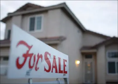  ??  ?? A for sale sign stands outside a home for sale on Branding Iron Drive in Imperial. Under the Building Homes and Jobs Act, owner-occupied home sales and commercial real-estate sales will be exempt from the new $75 per document fee county recorders will...