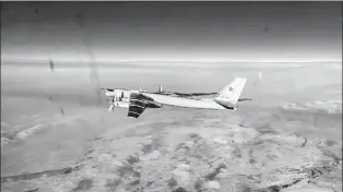  ?? RUSSIAN DEFENSE MINISTRY PRESS SERVICE VIA AP ?? In this handout photo taken from video released by Russian Defense Ministry Press Service on Tuesday, a Tu-95 strategic bomber of the Russian air force is seen from another one during their mission.