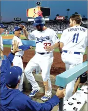  ?? File-The Associated Press ?? Charlie Culberson (37) high-fives teammates after scoring a run during the NLCS in October.